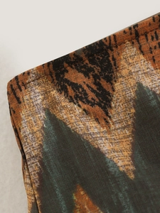 Macro shot of high-waisted Y2K skirt showing landscape print and precise stitching details