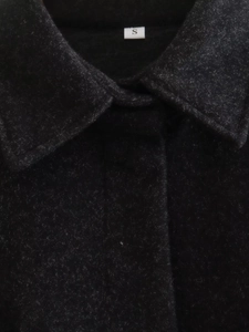 Detail shot of black woolen fabric collar with visible S size label for Y2K loose jacket