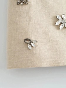 Detail of Y2K sequined mini skirt featuring intricate floral hand-beaded crystal embellishments