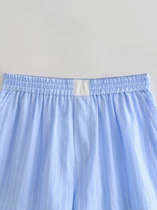 Detail of light blue striped shorts showing elastic waistband and white woven label