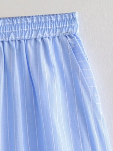 Detail of light blue striped shorts showing elastic waistband and side pocket seams