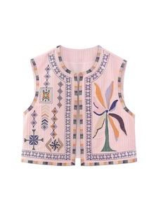 Detailed embroidery on pink Y2K vest featuring colorful palm tree and geometric patterns