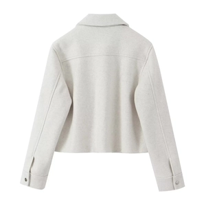 Back view of a cropped Y2K style tweed jacket in beige with metal button sleeve details