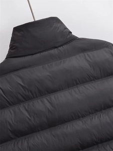 Detailansicht des Stehkragens und der horizontalen Steppung dieser schwarzen Steppjacke