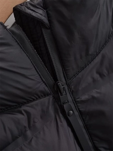 Nahaufnahme der schwarzen Steppjacke mit Metallreißverschluss und mattierter Stoffstruktur