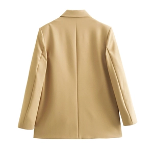 Detail view of the back of a beige oversized suit jacket with lapel and center seam