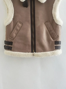 Detail of dark khaki faux suede vest with zipper, sheepskin wool collar and leather buckles