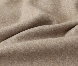 Macro shot of soft camel wool fabric texture with rich fuzzy feel on Y2K street jacket