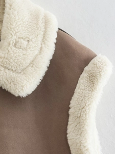 Detail of brown faux suede texture and thick white lamb wool lining on a cozy winter vest