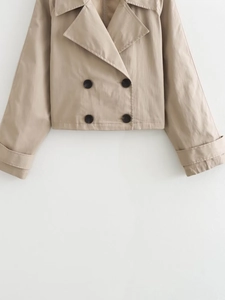 Detailed view of khaki double-breasted trench jacket with buttons and cuff straps