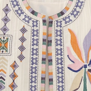 White sleeveless Y2K vest with ethnic colorful embroidery and bohemian patterns