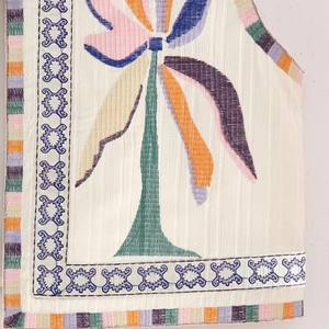 Y2K style white sleeveless vest with colorful floral embroidery and geometric trim details