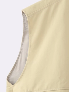 Detailed close-up showing reinforced double stitching and beige vest fabric texture