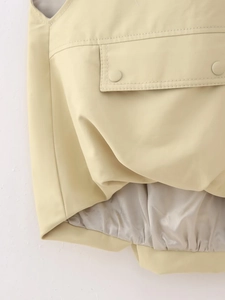 Y2K style beige cropped vest with utility flap pockets and adjustable drawstring hem