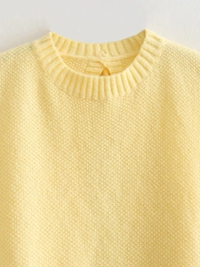 Y2K yellow sleeveless knit vest featuring a round neck and textured honeycomb pattern