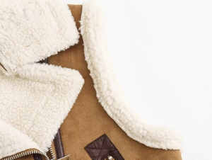 Gros plan du gilet vintage Y2K en daim avec col en peau de mouton et détails de zip