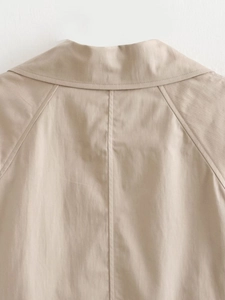 Macro shot of back collar and raglan sleeve stitching on khaki slim fit trench coat