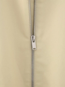 Close-up of silver metal zipper detail on khaki Y2K street style vest jacket