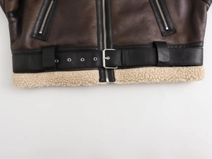 Detailed close-up of dark brown PU leather biker jacket with fur lining and waist belt