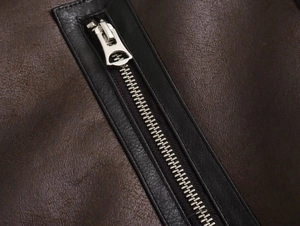 Detailed close-up of premium dark brown PU leather texture and silver metal zipper