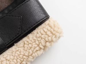 Close-up of black lychee grain leather jacket with warm cream-colored faux fur lining