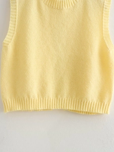 Detailed close-up of yellow knitted Y2K vest showing waffle texture and ribbed edges