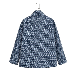 Detailed back view of Y2K blue jacket with white geometric diamond patterns and print