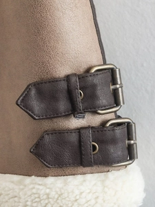 Detailed view of winter boots with double buckles and thick warm lamb wool lining