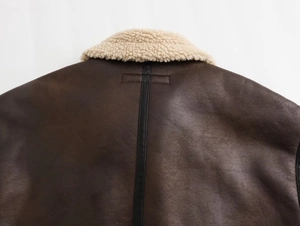 Back view of a Y2K faux shearling biker jacket with dark brown leather and black trim