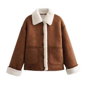 Close-up of caramel suede jacket texture with thick white shearling lining and pockets