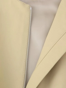 Close-up of premium metal zipper and woven texture on a khaki Y2K vest jacket