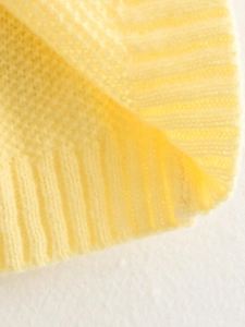 Pale yellow Y2K knitted vest showing detailed ribbed knit texture and soft fabric finish