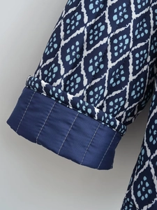 Detailed view of quilted cuffs and ethnic geometric print on Y2K vintage padded jacket