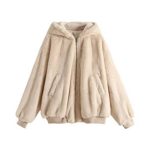 Detailed macro view of the cream white faux fur texture and elastic cuffs on bomber jacket