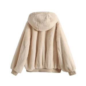 Detail of beige faux fur hooded jacket showing soft texture and ribbed cuffs