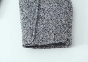 Close-up macro detail of gray bouclé fabric cuff with premium heavy textured stitching