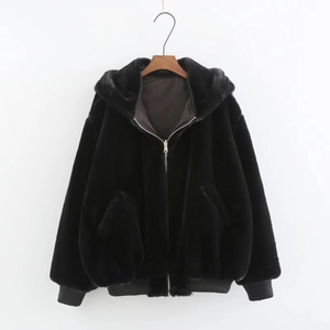 Detailed view of black faux fur bomber jacket with zip-up hood and ribbed cuffs