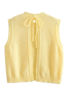 Y2K yellow knit vest with an open back and bow tie detailing on a white background
