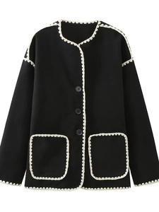 Women's black wool jacket with cream crochet lace trim and elegant button closure