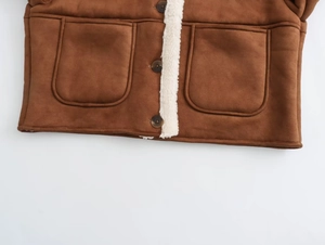 Detailed view of brown suede jacket showing textured faux lamb wool lining and large pockets