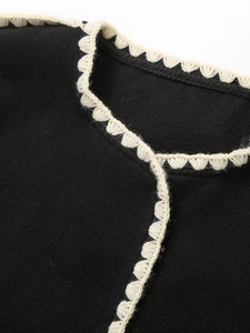 Women's black woolen coat featuring elegant contrast crochet lace collar and edges