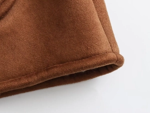 Detail of brown faux suede fabric showing premium stitching and thick rolled edge texture