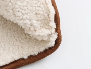Detailed view of brown suede jacket with soft white sherpa lining for warmth