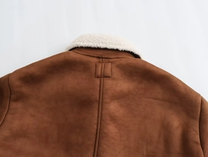 Detail view of the brown faux suede jacket back with white sherpa collar and stitching