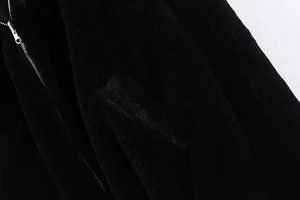 Close-up of premium black faux fur texture with high-quality silver metal zipper detail