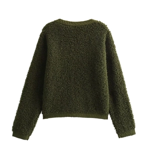 Rear view detail of dark green bouclé knit cardigan showing textured yarn fabric
