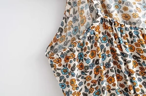 Detail of adjustable strap with metal buckle and elastic floral fabric for summer dress