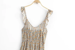 Detailed view of floral ruffle strap dress with deep V-neck and smocked waist design