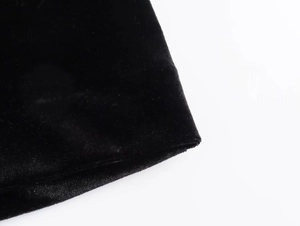 Close-up of premium black velvet fabric showing thick texture and soft material luster