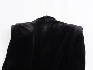 Detail view of the velvet dress back showing a concealed zipper on the neckline